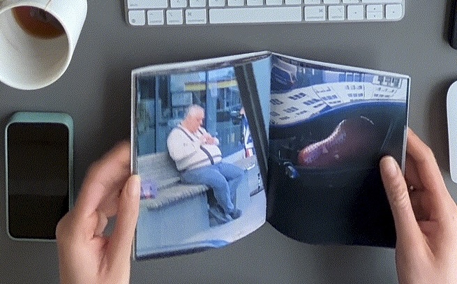 A still of the book, open on a spread. The photo on the left shows a man sitting on a public bench, scrolling his phone. The photo on the right shows a large, peanut-shaped exercise ball sitting in the passenger seat of a car.